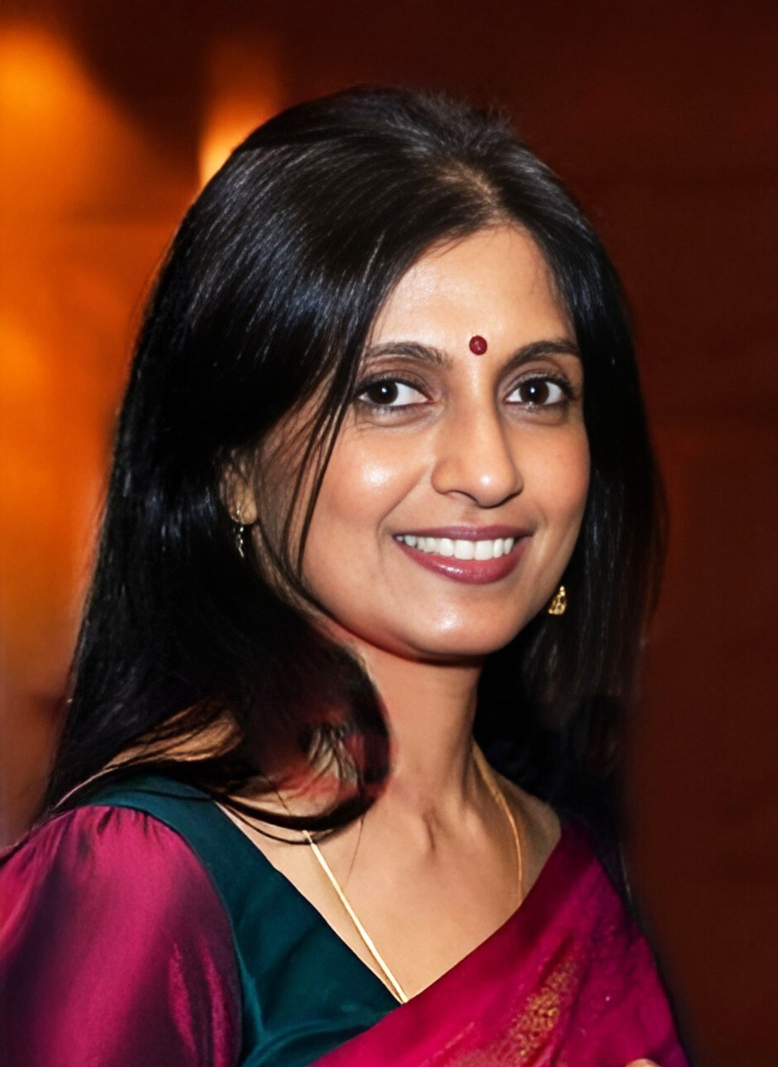 Sumethirai Nandhakumaran smiling in traditional Sri Lankan attire, whose legacy continues to shape early education access for children in need.